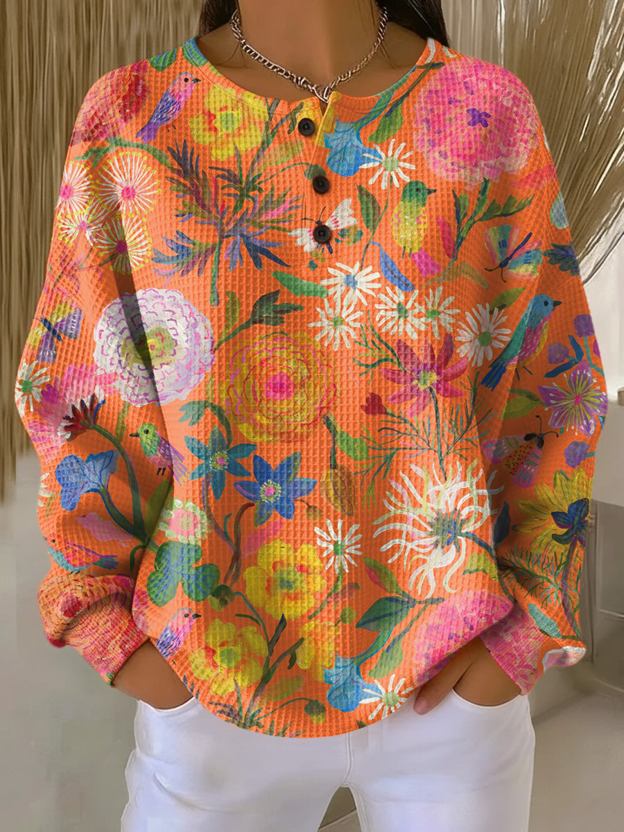 Eline | Oranje trui met bloemen