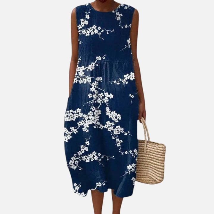 Tineke | Mouwloze midi-jurk met kersenbloesem op marineblauw