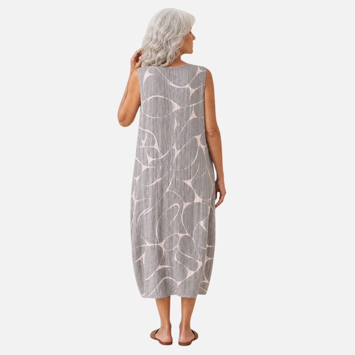 Margriet | Mouwloze midi-jurk met abstract vogelpatroon in grijs
