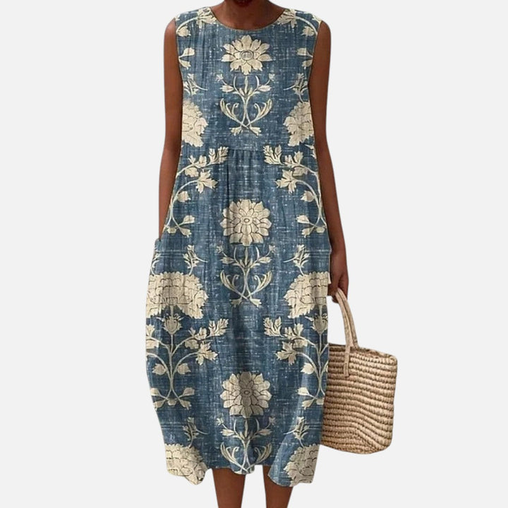 Lianne | Mouwloze midi-jurk met crèmekleurige bloemen op blauw